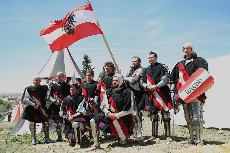 a group of men in armor holding flags