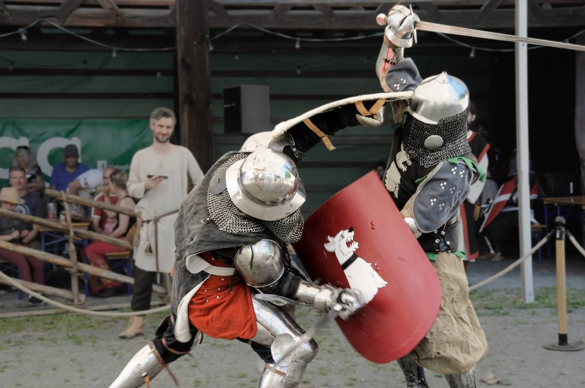 two men in armor fighting with swords