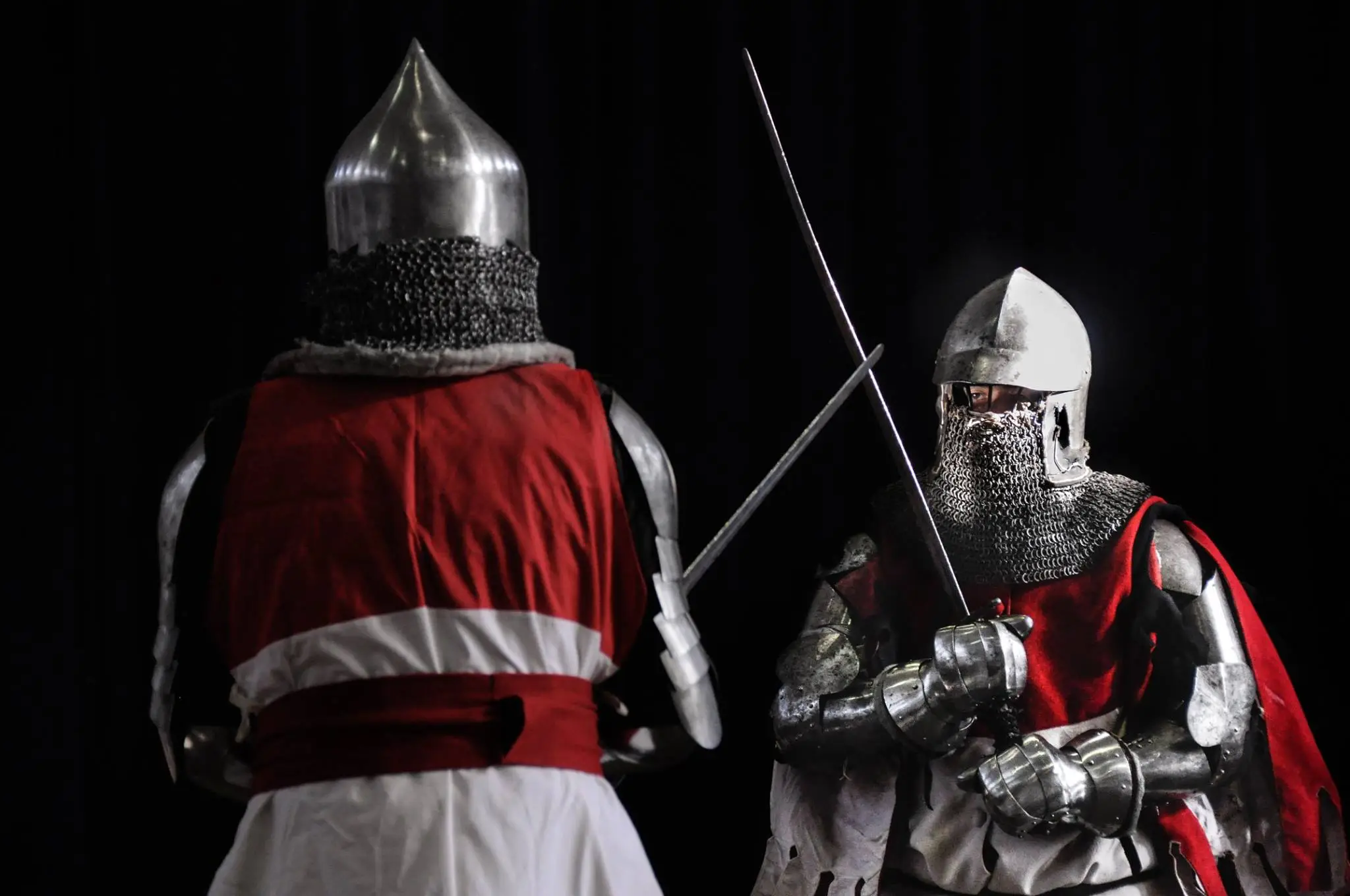 two men in armor holding swords