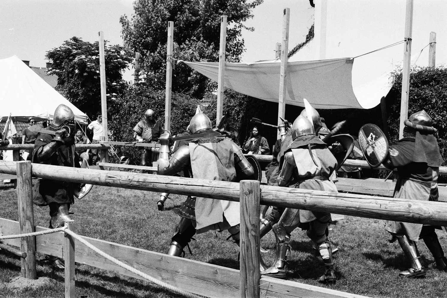 A group of men dressed in medieval clothing are playing a game.