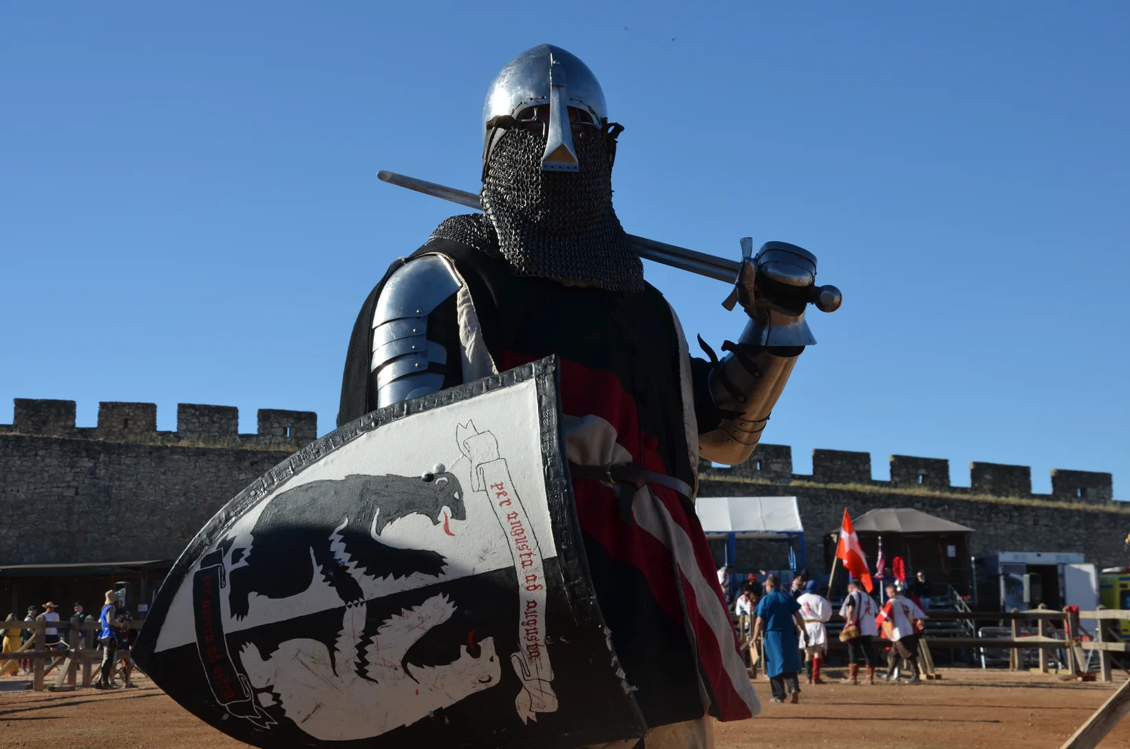 a person in a garment holding a sword and shield